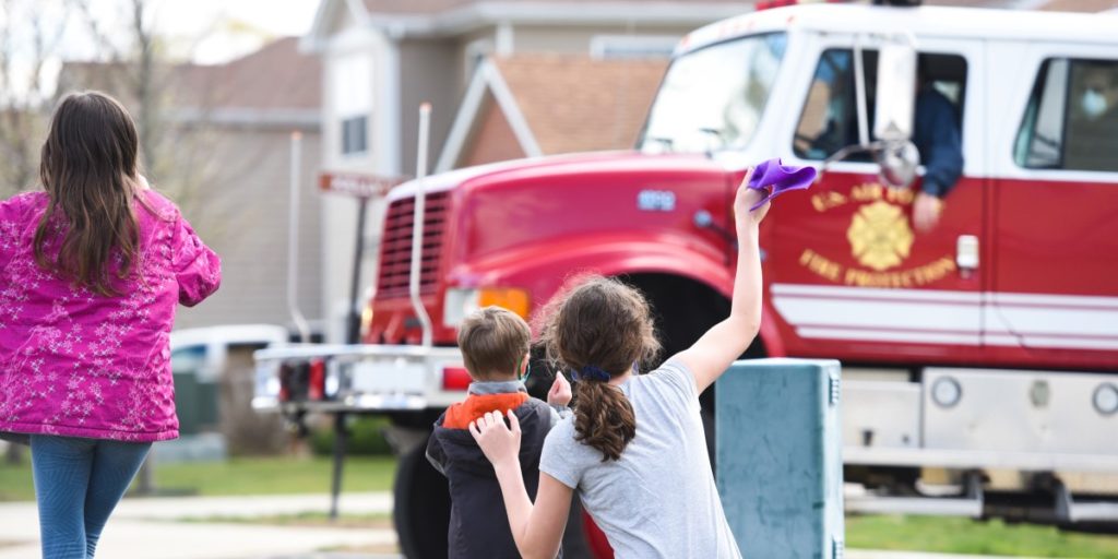 Kids waving to fire truck