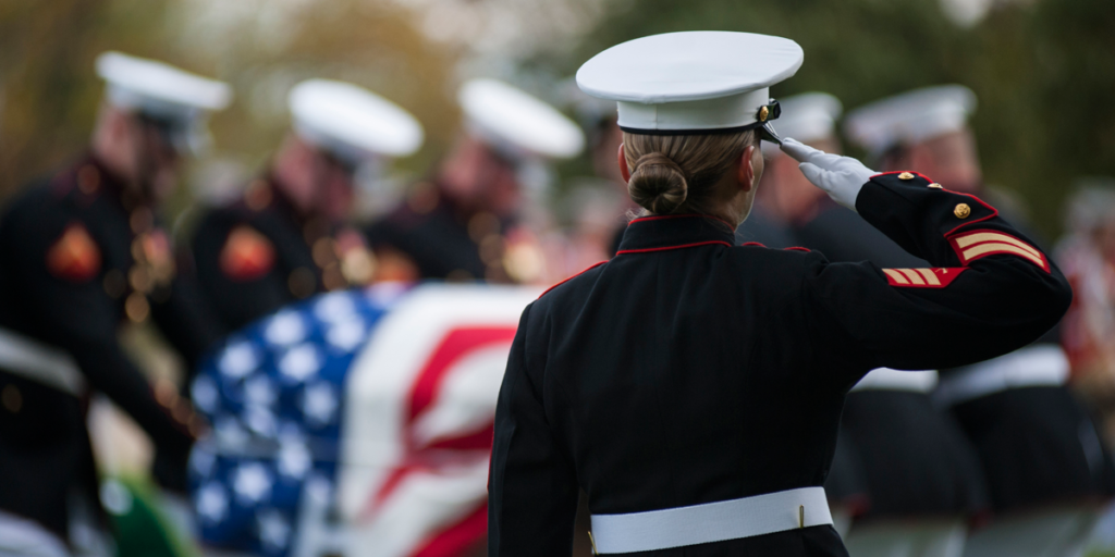 Female Marine salutes flag draped casket