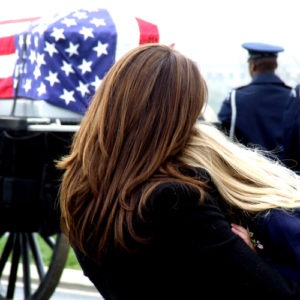 Women consoling each other at a funeral